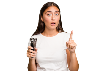 Young caucasian woman holding a razor isolated having an idea, inspiration concept.