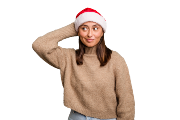 Young caucasian woman celebrating christmas wearing a santa hat isolated touching back of head, thinking and making a choice.