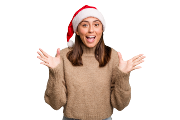Young caucasian woman celebrating christmas wearing a santa hat isolated receiving a pleasant surprise, excited and raising hands.
