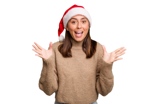 Young caucasian woman celebrating christmas wearing a santa hat isolated receiving a pleasant surprise, excited and raising hands. - Powered by Adobe