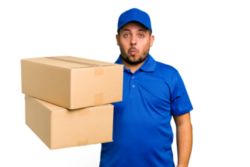 Delivery caucasian man isolated shrugs shoulders and open eyes confused.