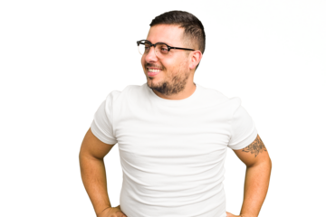 Young caucasian man isolated laughs happily and has fun keeping hands on stomach.