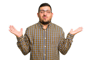 Young caucasian man isolated doubting and shrugging shoulders in questioning gesture.