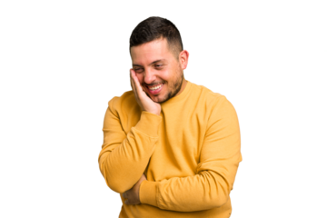 Young caucasian man isolated laughs happily and has fun keeping hands on stomach.