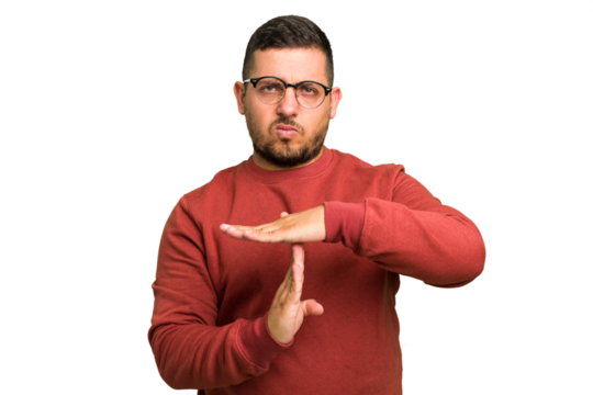 Young caucasian man isolated showing a timeout gesture.