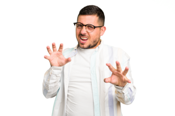 Young caucasian man isolated upset screaming with tense hands.