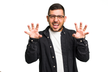 Young caucasian man isolated showing claws imitating a cat, aggressive gesture.
