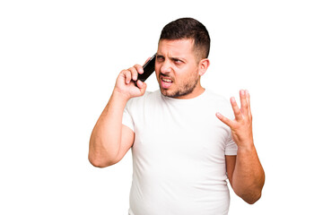 Young caucasian man using mobile phone isolated