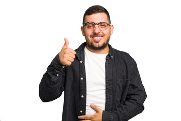 Young caucasian man isolated touches tummy, smiles gently, eating and satisfaction concept.