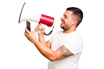 Young caucasian man holding a megaphone isolated