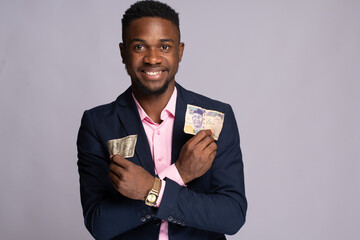 black businessman holding naira and dollar notes