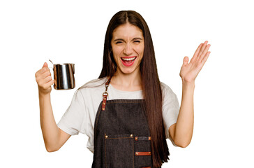 Young barista caucasian woman isolated receiving a pleasant surprise, excited and raising hands.