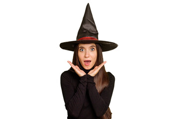 Young caucasian woman dressed as a witch for halloween day isolated surprised and shocked.