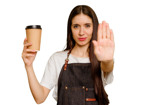 Young barista woman holding a takeaway coffee isolated standing with outstretched hand showing stop sign, preventing you.