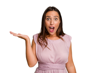 Young caucasian cute woman isolated impressed holding copy space on palm.