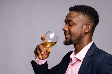 young african businessman sipping wine