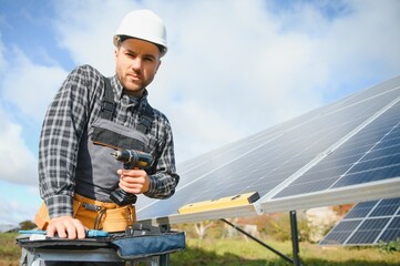 A handyman standing on the rooftop with solar panels and smiling at the camera.