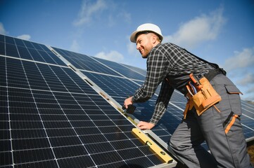 Worker installing solar panels outdoors