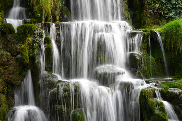 A cascade of waterfalls showing the flow of water falling down over rocks