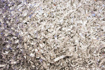 Silver confetti background. Bright shiny confetti lying on the table.