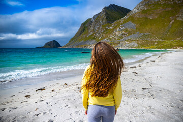 close-up on shiny long hair of a beautiful girl walking on the famous haukland beach on lofoten...