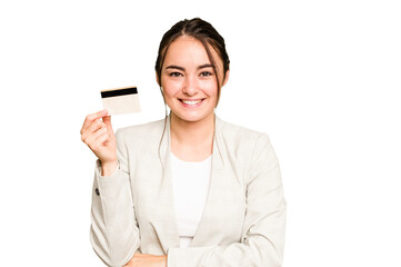 Young caucasian woman holding a credit card isolated on green chroma background laughing and having...