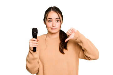 Young caucasian singer woman isolated on green chroma background showing a dislike gesture, thumbs down. Disagreement concept.