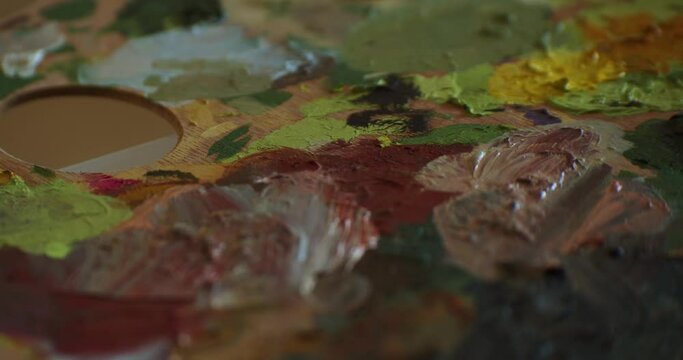 Artist's Wooden Palette With Dry Paints. - close up