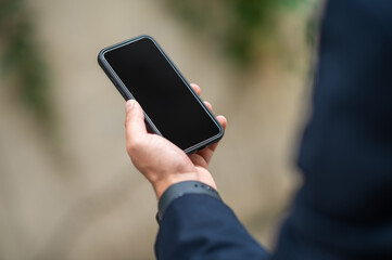Close up picture of a males hand with a smartphone