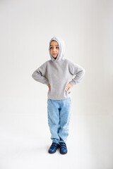Fototapeta premium Boy child preschooler smiling and posing on gray background in photo studio