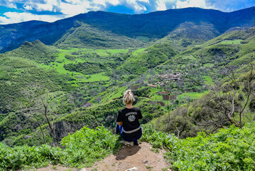 A girl on the background of a mountain view from the territory of the Tatev monastery of the 9th century, Armenia 2019 - obrazy, fototapety, plakaty
