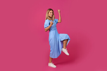 Happy excited adult european woman doing success gesture and celebrating victory