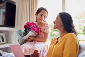 Daughter Giving Mother Bunch Of Flowers For Birthday Or Mothers Day At Home