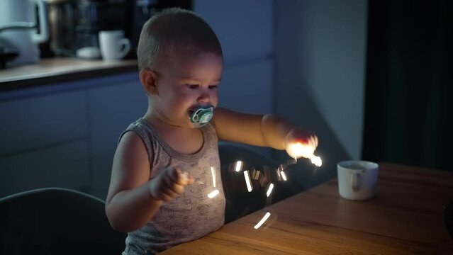 Snotty kid spoiling at the kitchen table with swag.	