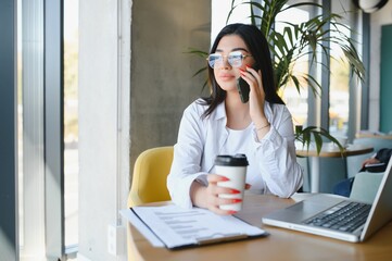 Smiling girl student study online with skype teacher, happy young woman learn language listen...