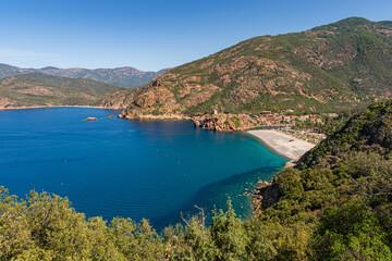 The small harbor and beach in Porto on the remote west coast of Corsica, France
