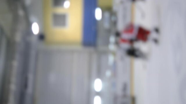 Blurred background. Teams of hockey players playing hockey. Boys play hockey on ice rink at ice stadium. Ice Hockey match championship Sports skating competitions Real professional game Vertical video