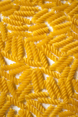 Vertical close up photo of fusilli - Italian durum wheat dry pasta