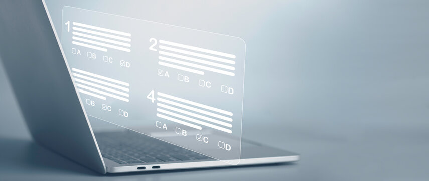 Virtual Test Or Questionnaire Show On Screen And Answer Check Mark To Measure Grades. Education Futuristic Technology. Students Taking Online Exams By Laptop And Lifelong Learning Concept.