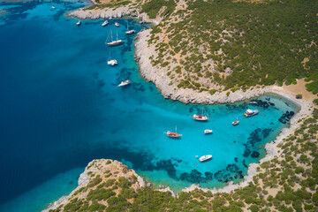 Aerial view of blue sea lagoon and yachts along the mediterranean coast. Landscape of turkish riviera nature - obrazy, fototapety, plakaty