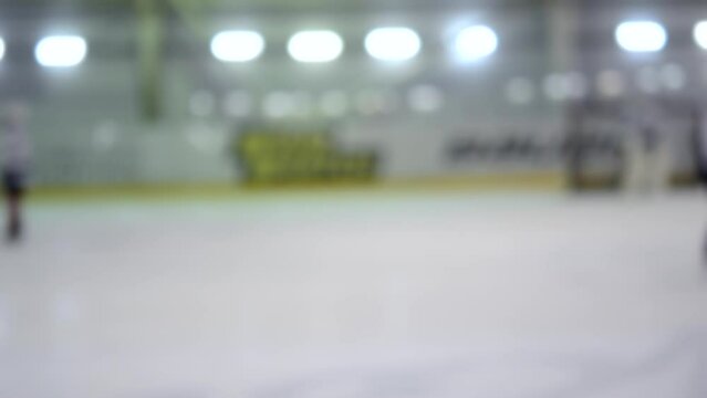 Blurred background. Teams of hockey players playing hockey. Teenage boys play hockey on ice rink at indoor ice stadium. Ice Hockey match championship Sports skating competitions Real professional game