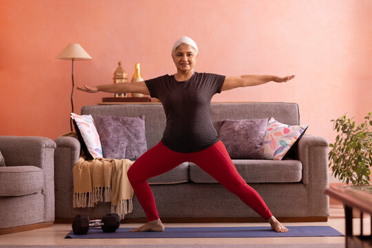 Portrait of an active old woman exercising at home