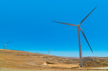 A view of wind turbines above the gorge at Little Petra, Jordan in summertime