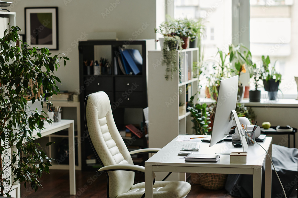 Poster Workplace of modern manager or creative webdesigner with computer monitor standing on desk with office supplies and armchair near by