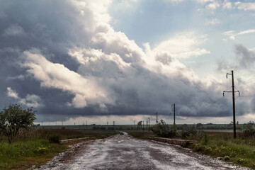 Rural road in field landscape photo. Beautiful nature scenery photography with vintage car on background. Idyllic scene. High quality picture for wallpaper, travel blog, magazine, article