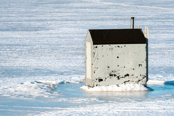 Ice fishing on a frozen harbor in rural Prince Edward Island, Canada.