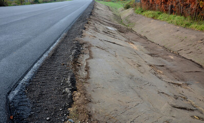A newly built road, on the layer of which you can see successive layers of screed and asphalt...
