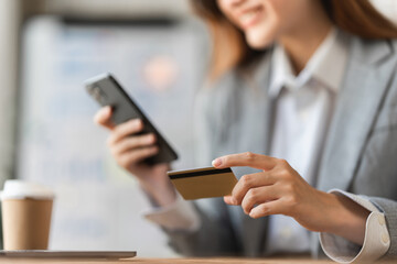 Young person using credit card and mobile phone. Online shopping, e-commerce concept
