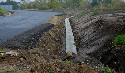 A newly built road, on the layer of which you can see successive layers of screed and asphalt...
