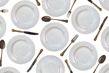Pattern of vintage dinner plates, knives, forks and spoons